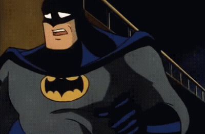 A Cartoon Of Batman Is Standing In Front Of A Building With His Mouth Open . GIF