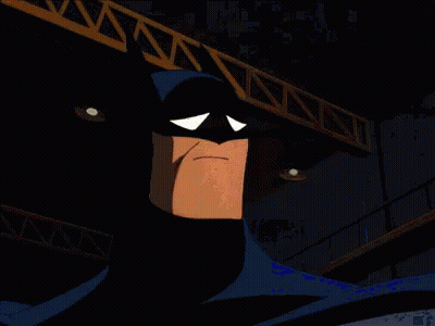 A Cartoon Of Batman Making A Sad Face In A Dark Room GIF