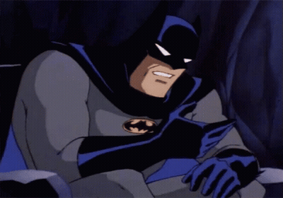 A Cartoon Of Batman Reading A Book With A Smile On His Face GIF