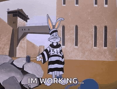 A Cartoon Of Bugs Bunny Holding A Hammer And Saying Im Working GIF