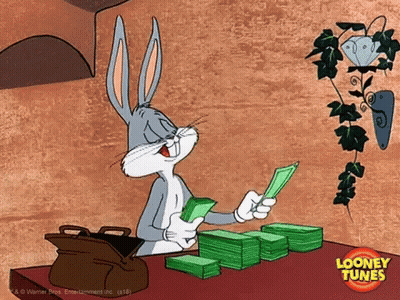 A Cartoon Of Bugs Bunny Sitting At A Table With A Stack Of Money GIF