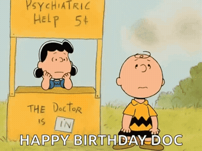 A Cartoon Of Charlie Brown And Lucy Brown In Front Of A Psychiatric Help Stand GIF