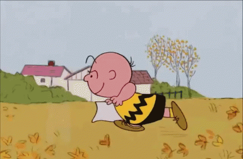 A Cartoon Of Charlie Brown Is Holding A Pillow GIF