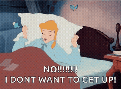 A Cartoon Of Cinderella Laying In Bed With A Pillow Over Her Head And The Words `` I Dont Want To Get Up '' GIF