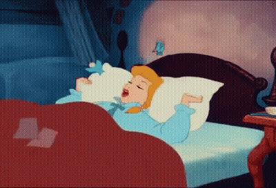 A Cartoon Of Cinderella Yawning In Bed With A Bird On Her Pillow . GIF