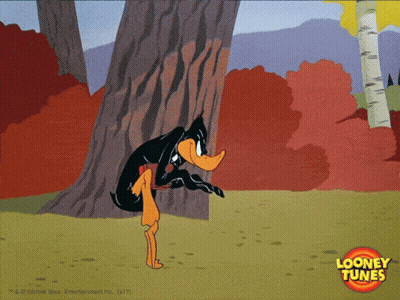 A Cartoon Of Daffy Duck Peeking Out From Behind A Tree With A Looney Tunes Logo In The Corner GIF