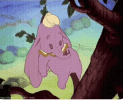 A Cartoon Of Dumbo Hanging On A Tree Branch GIF