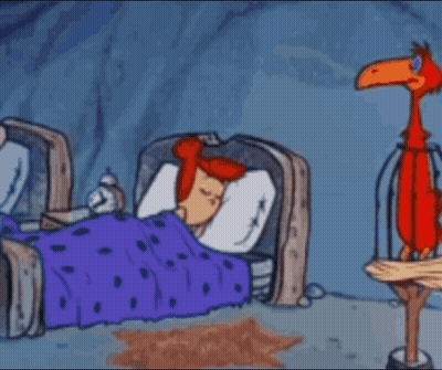 A Cartoon Of Flintstone Holding A Towel In Front Of A Sleeping Man And Woman . GIF