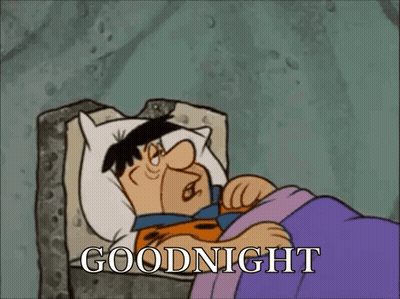 A Cartoon Of Flintstone Laying In Bed With The Words Goodnight Written Above Him GIF