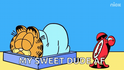A Cartoon Of Garfield Laying In A Box Next To An Alarm Clock That Says Ring GIF