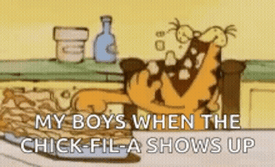 A Cartoon Of Garfield Sitting On A Couch Eating Chicken Nuggets . GIF