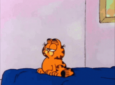 A Cartoon Of Garfield Standing On A Bed With His Eyes Closed GIF