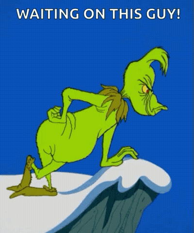 A Cartoon Of Grinch Standing On A Cliff With The Words " Waiting On This Guy " Below Him GIF