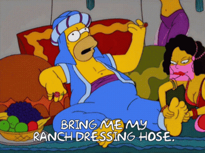 A Cartoon Of Homer Simpson Laying On A Couch With The Words Bring Me My Ranch Dressing Hose On The Bottom GIF