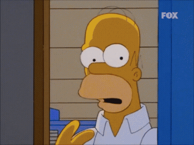 A Cartoon Of Homer Simpson Standing In Front Of A Fox Sign GIF