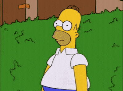 A Cartoon Of Homer Simpson Standing In Front Of A Green Bush GIF