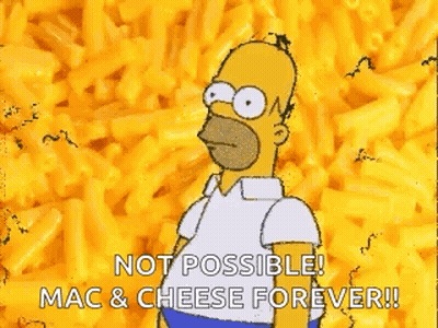 A Cartoon Of Homer Simpson Standing In Front Of A Pile Of Macaroni Cheese . GIF