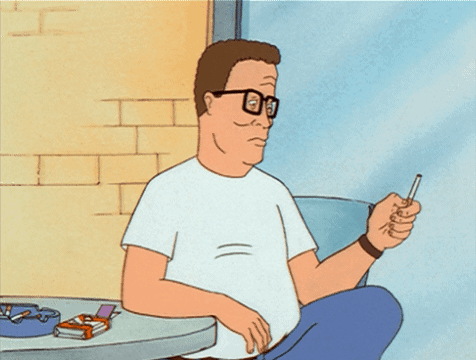 A Cartoon Of King Of The Hill Sitting At A Table With A Cigarette In His Mouth GIF