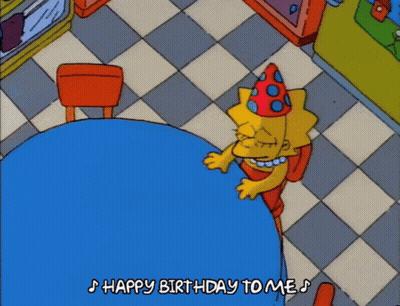 A Cartoon Of Lisa Simpson Sitting At A Table With The Words Happy Birthday To Me Below Her GIF