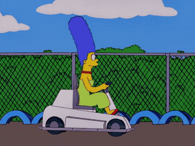 A Cartoon Of Marge Simpson Driving A Small White Car GIF