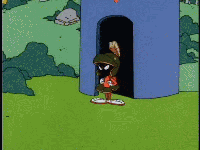 A Cartoon Of Marvin The Martian Standing In Front Of A Blue Tower GIF