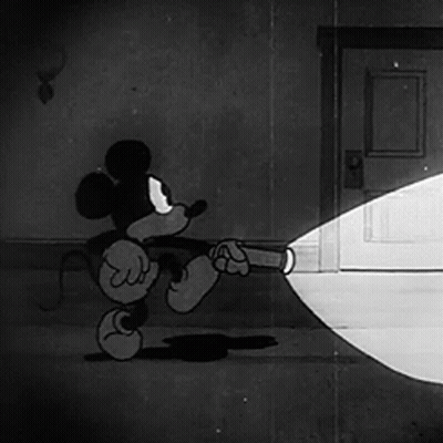 A Cartoon Of Mickey Mouse Holding A Flashlight GIF