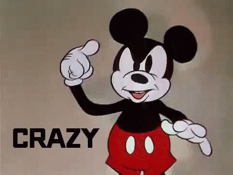 A Cartoon Of Mickey Mouse Pointing At Something With The Word Crazy Behind Him . GIF