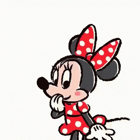 A Cartoon Of Minnie Mouse Standing In Front Of A Red Heart . GIF