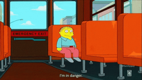 A Cartoon Of Ralph From The Simpsons Sits In An Orange Seat GIF