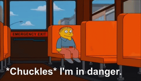A Cartoon Of Ralph From The Simpsons Sits In An Orange Seat GIF