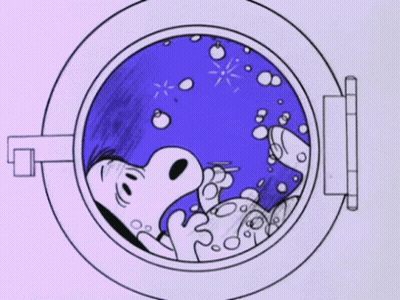A Cartoon Of Snoopy Laying In A Washing Machine . GIF