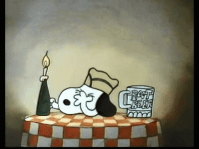 A Cartoon Of Snoopy Laying On A Checkered Table Next To A Mug That Says Frost Beer GIF