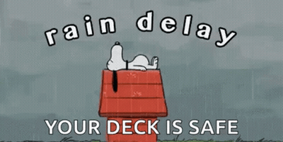 A Cartoon Of Snoopy Laying On Top Of A Wooden House In The Rain . GIF