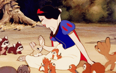 A Cartoon Of Snow White Sitting On The Ground With Squirrels GIF