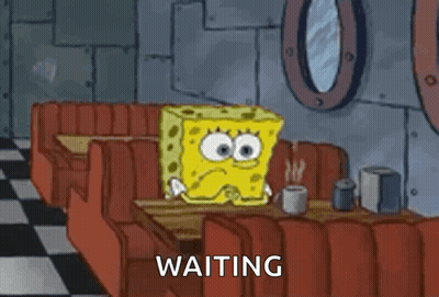 A Cartoon Of Spongebob Squarepants Sitting At A Table In A Diner . GIF
