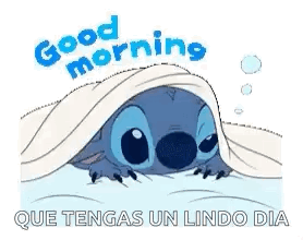 A Cartoon Of Stitch Laying Under A Blanket With The Words `` Good Morning Que Tengas Un Lindo Dia '' GIF