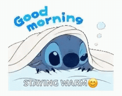 A Cartoon Of Stitch Laying Under A Blanket With The Words `` Good Morning , Staying Warm '' . GIF