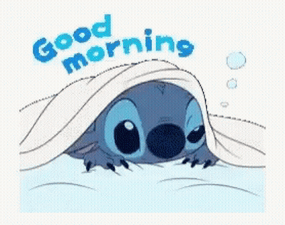 A Cartoon Of Stitch Laying Under A Blanket With The Words `` Good Morning '' Written Above Him . GIF