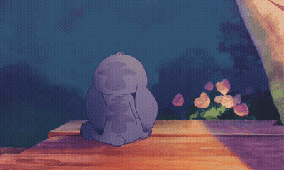 A Cartoon Of Stitch Sitting On A Wooden Bench GIF