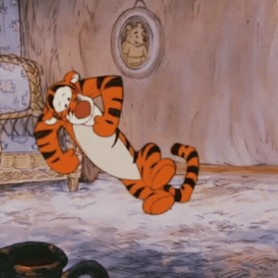 A Cartoon Of Tigger From Winnie The Pooh Laying On The Floor GIF