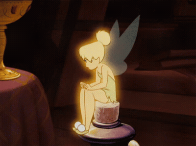A Cartoon Of Tinkerbell Sitting On A Candle Holder GIF