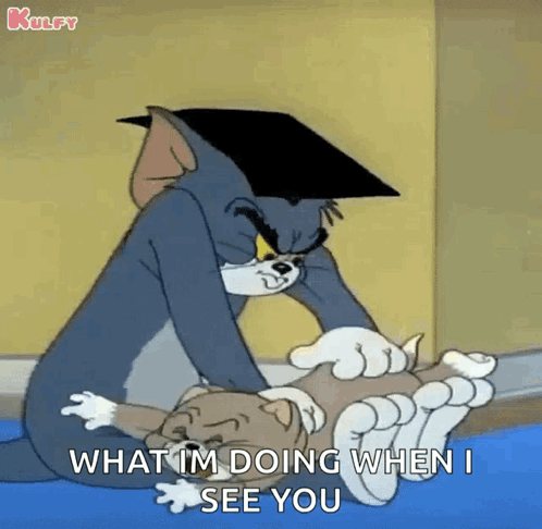 A Cartoon Of Tom And Jerry Laying On The Floor . GIF