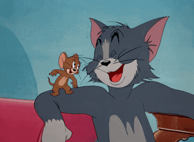 A Cartoon Of Tom And Jerry Sitting On A Red Couch GIF
