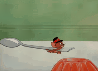A Cartoon Of Tom Wearing A Feathered Headdress GIF