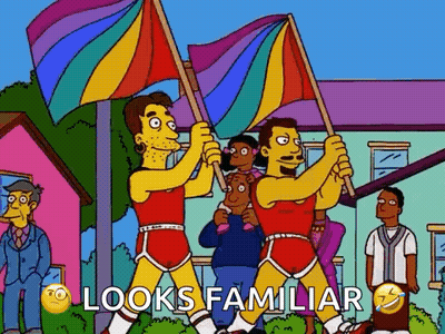 A Cartoon Of Two Men Holding Rainbow Flags With The Words Looks Familiar Below Them . GIF