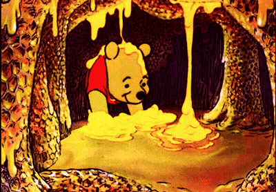 A Cartoon Of Winnie The Pooh In A Honeycomb GIF