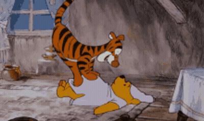 A Cartoon Of Winnie The Pooh Laying On The Floor With A Tiger On Top Of Him GIF