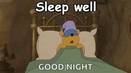 A Cartoon Of Winnie The Pooh Sleeping In A Bed With A Sleep Cap On . GIF