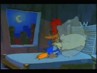 A Cartoon Of Woody Woodpecker Laying On A Bed In A Dark Room GIF
