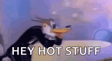 A Cartoon Penguin Is Wearing A Tuxedo And Saying `` Hey Hot Stuff '' While Sitting On A Bed . GIF